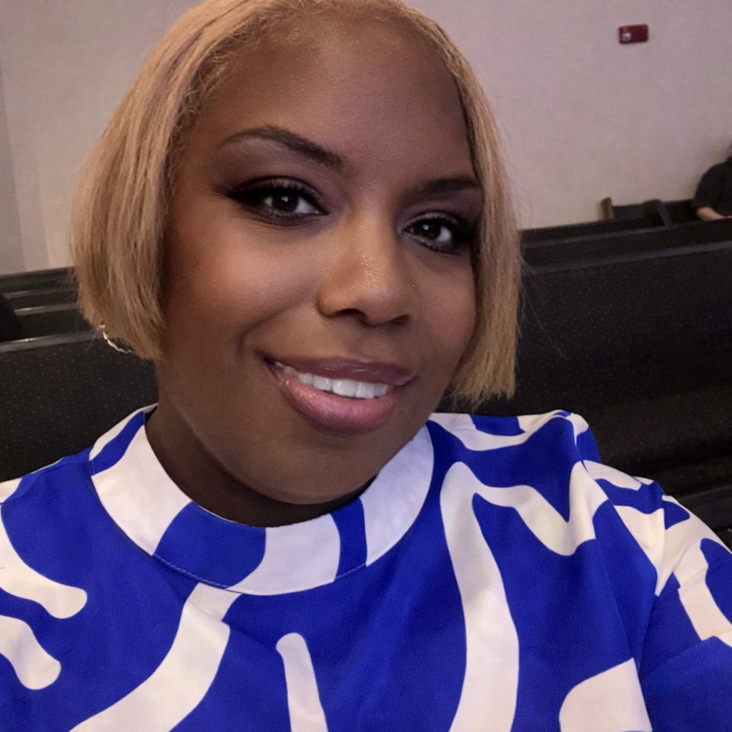 Shauniesa Sisk, founder of Miles of Love 9-2-5, smiling warmly